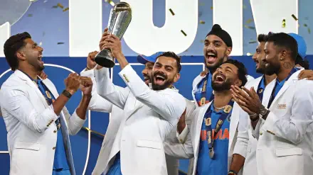 A celebration of victory at the ICC Champions Trophy, featuring jubilant players in white jackets lifting the trophy, surrounded by confetti and smiles. HD desktop wallpaper.