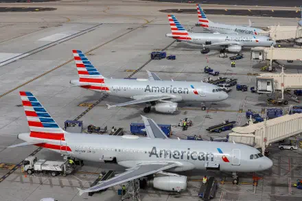 Three American Airlines airplanes are parked at an airport terminal, showcasing a busy scene in a 4K Ultra HD PC desktop wallpaper. Airport staff and equipment are visible nearby.