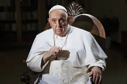 Pope Francis seated in a chair, wearing traditional papal attire, with a serious expression. This image serves as a striking HD desktop wallpaper and background.