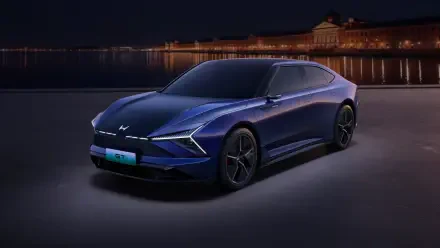 Sleek blue Honda GT electric car showcased at night with city lights in the background, rendered in 4K Ultra HD for PC desktop wallpaper.