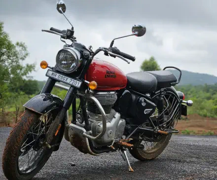 HD desktop wallpaper featuring a Royal Enfield Classic 350 race bike captured in sharp photography against a natural outdoor backdrop.