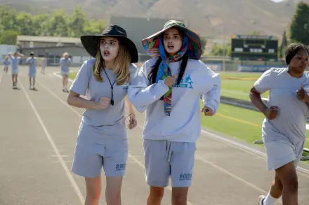 Scene from the movie Freakier Friday showing two characters jogging on a track, featured as an 8K Ultra HD PC desktop wallpaper and background.