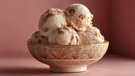 A bowl of creamy ice cream scoops with a textured pattern sits against a soft pink background, captured in stunning 4K Ultra HD as a comforting food desktop wallpaper.