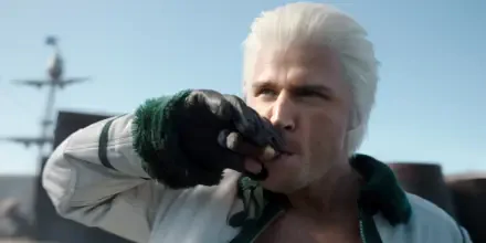 HD PC wallpaper of Smoker from One Piece (live-action): close-up of the white-haired marine officer lifting a cigar to his lips against a pale blue sky.