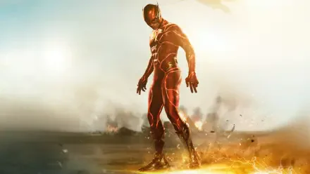The Flash (2023) in his red suit stands amid sparks and lightning on scorched ground — cinematic 4K Ultra HD PC desktop wallpaper and background.