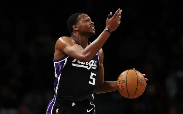 De'Aaron Fox of the Sacramento Kings in action during an NBA game, showcasing his skills with a basketball in hand, captured in a dynamic HD desktop wallpaper.