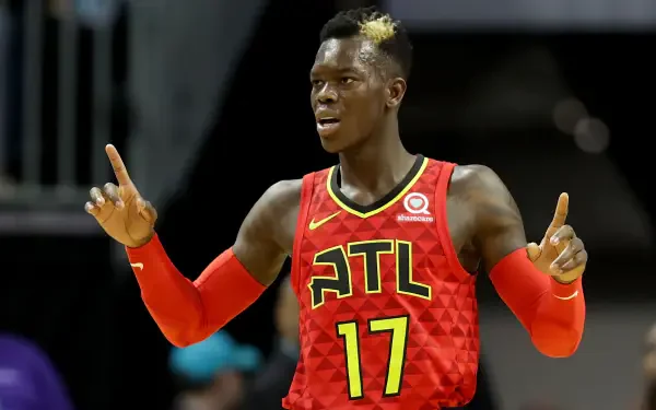 Dennis Schröder celebrates during an NBA game, wearing the Atlanta Hawks' red uniform with the number 17. A dynamic moment captured in a vibrant HD desktop wallpaper.