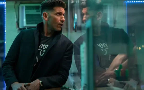 Jon Bernthal stars in The Accountant 2, depicted in a dramatic moment with reflections, showcased in a striking 4K Ultra HD wallpaper.