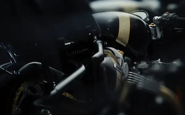 Close-up view of a Triumph Bonneville Bobber TFC motorcycle, showcasing its sleek design and intricate details. This 4K Ultra HD image serves as a stunning desktop wallpaper.