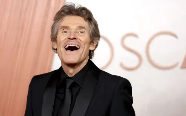 Willem Dafoe smiles brightly on the red carpet at the Academy Awards, captured in a vibrant 4K Ultra HD wallpaper.