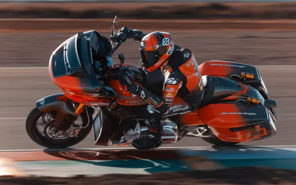 A vibrant Harley-Davidson CVO Road Glide RR motorcycle in motion, showcasing its sleek design and powerful presence against a dynamic background. Ideal for motorcycle enthusiasts.