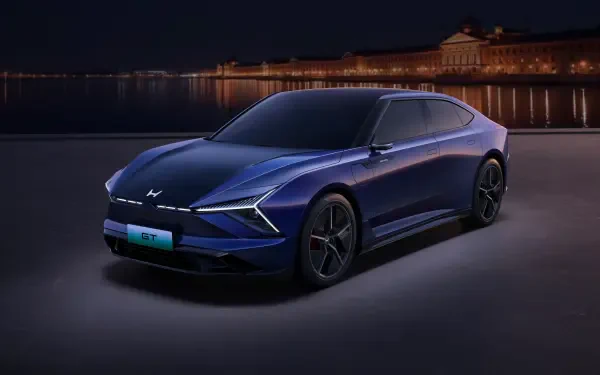 Sleek blue Honda GT electric car showcased at night with city lights in the background, rendered in 4K Ultra HD for PC desktop wallpaper.
