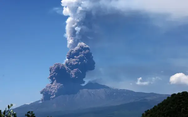 Eruption of a volcano in Sicily sending a towering ash cloud into the sky, captured in stunning 8K Ultra HD quality.