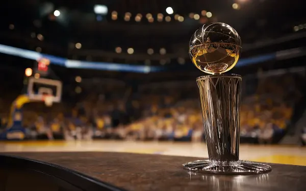 HD desktop wallpaper featuring the NBA Finals trophy prominently displayed on a basketball court during a game night.