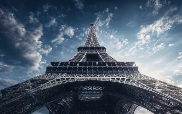 A stunning 4K Ultra HD desktop wallpaper capturing the Eiffel Tower from below against a dramatic sky backdrop.