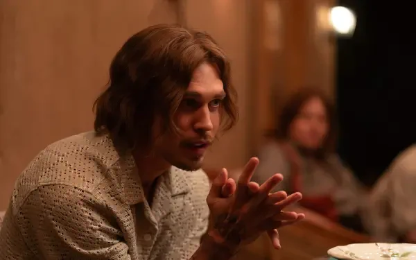 HD PC desktop wallpaper featuring Austin Butler in a movie scene from Eddington, showcasing a contemplative moment with warm indoor lighting.