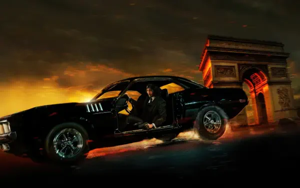 John Wick: Chapter 4 4K Ultra HD PC desktop wallpaper — suited figure stepping from a black muscle car with flaming skid marks, Arc de Triomphe glowing against a stormy, orange sky.