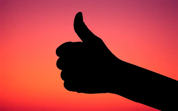 Silhouette of a hand giving a thumbs-up against a vivid sunset gradient — HD PC desktop wallpaper and background.