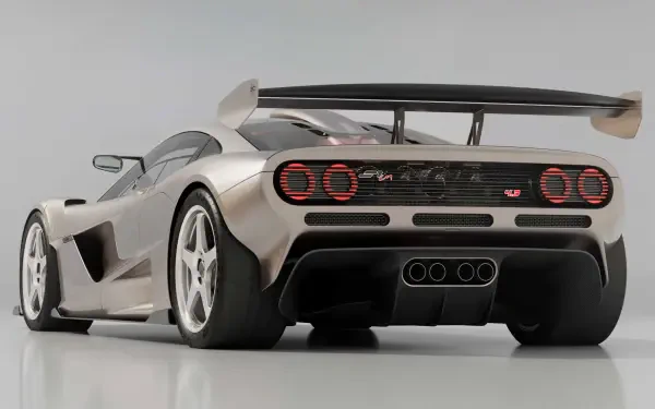 Silver Gordon Murray Automotive sports vehicle, rear three-quarter view with large wing, triple center exhausts and round taillights — HD PC desktop wallpaper background.