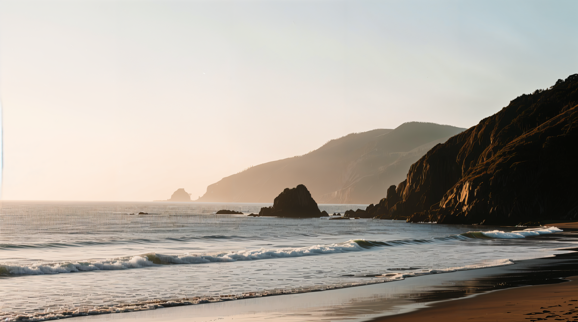 4K Ultra HD PC desktop wallpaper of a tranquil bay with gentle waves, a sandy shoreline and rugged headlands bathed in warm, hazy light.