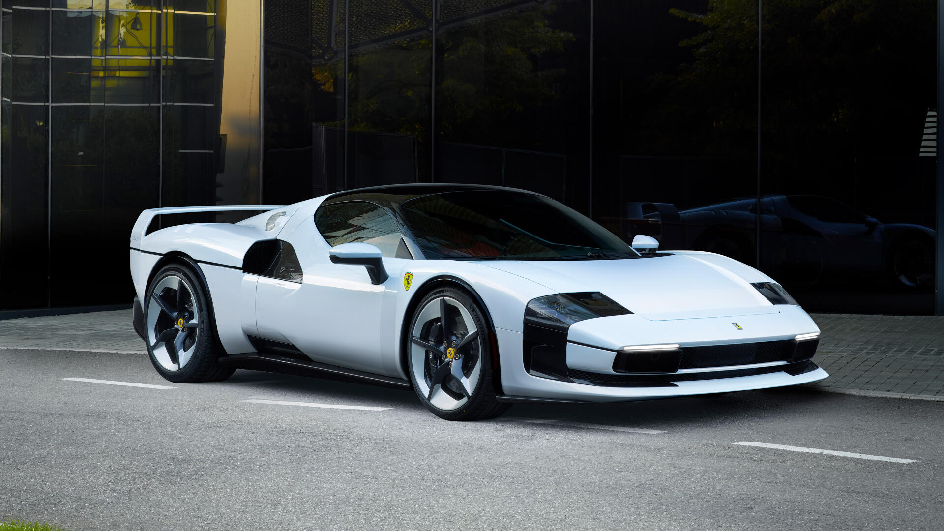 White Ferrari SC40 sports car parked before a dark glass facade, rendered as a 4K Ultra HD PC desktop wallpaper and background.