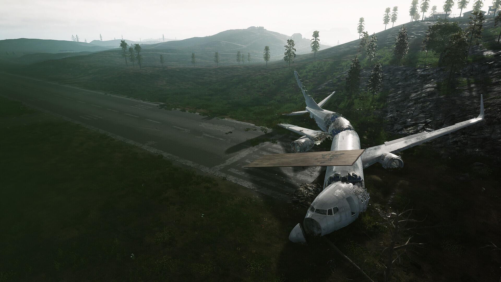 HD PC desktop wallpaper from the video game HumanitZ: a plane crash—an airliner wrecked in a misty green valley, surrounded by trees on rolling hills beneath an overcast sky.