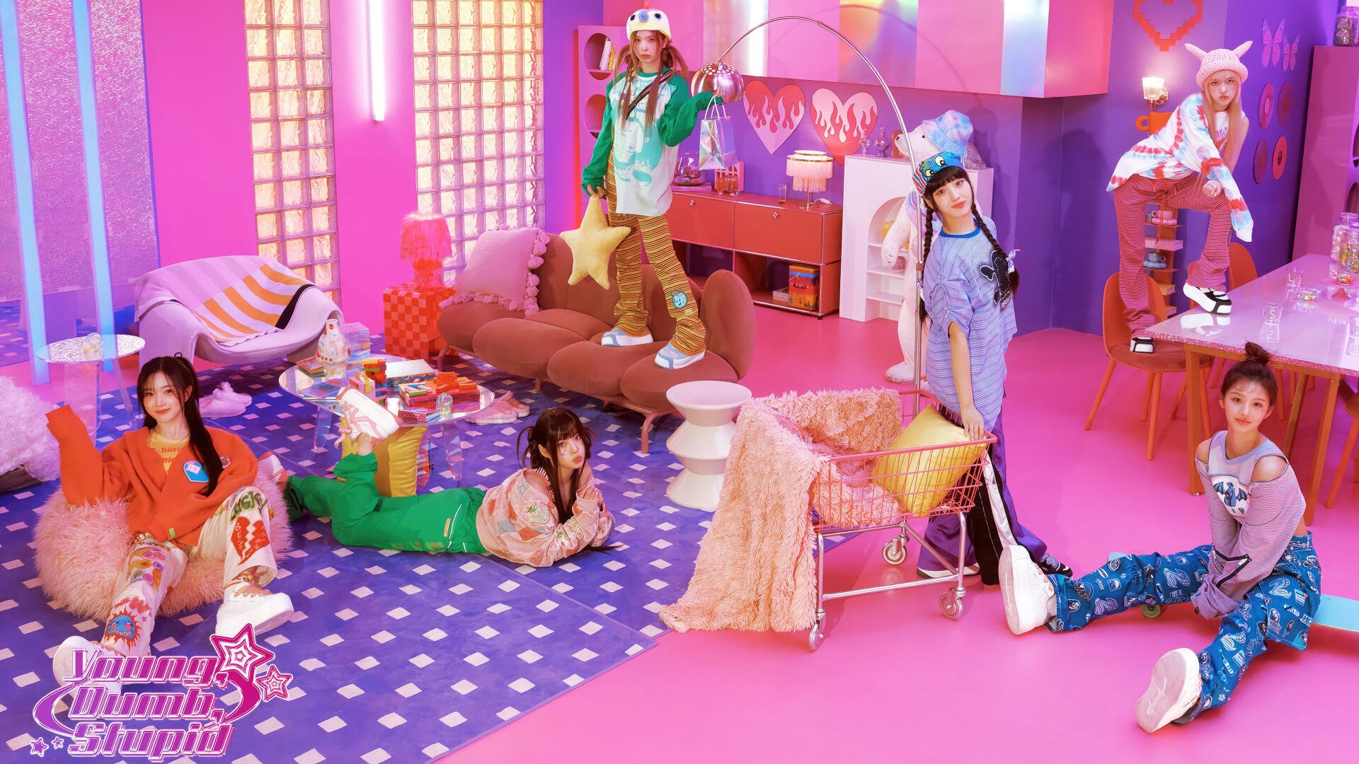 4K Ultra HD PC desktop wallpaper: y2k-inspired K-pop girl band in a bold pink room, colorful outfits and playful retro props.