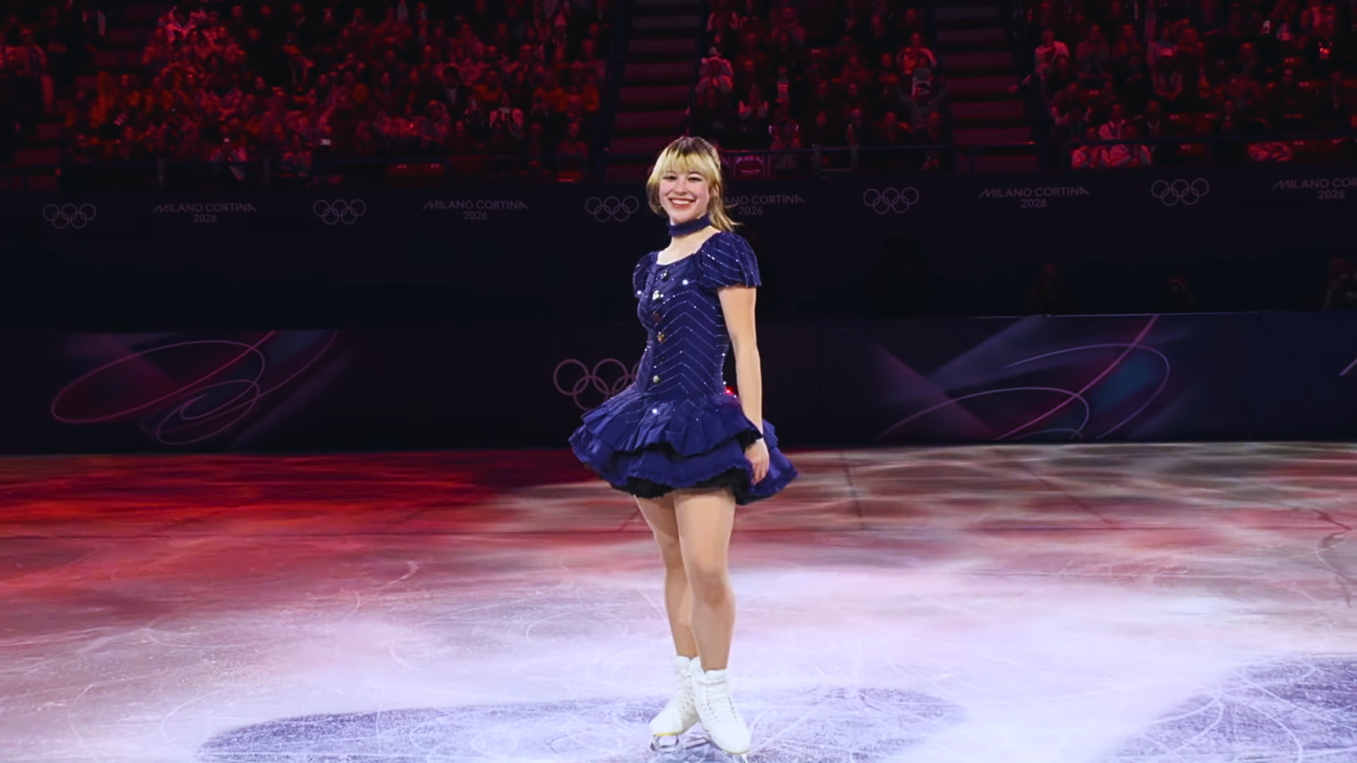 4K Ultra HD PC desktop wallpaper: figure skater in Team USA navy dress spins on Winter Olympics ice, bathed in lights amid a gold-medal celebration.