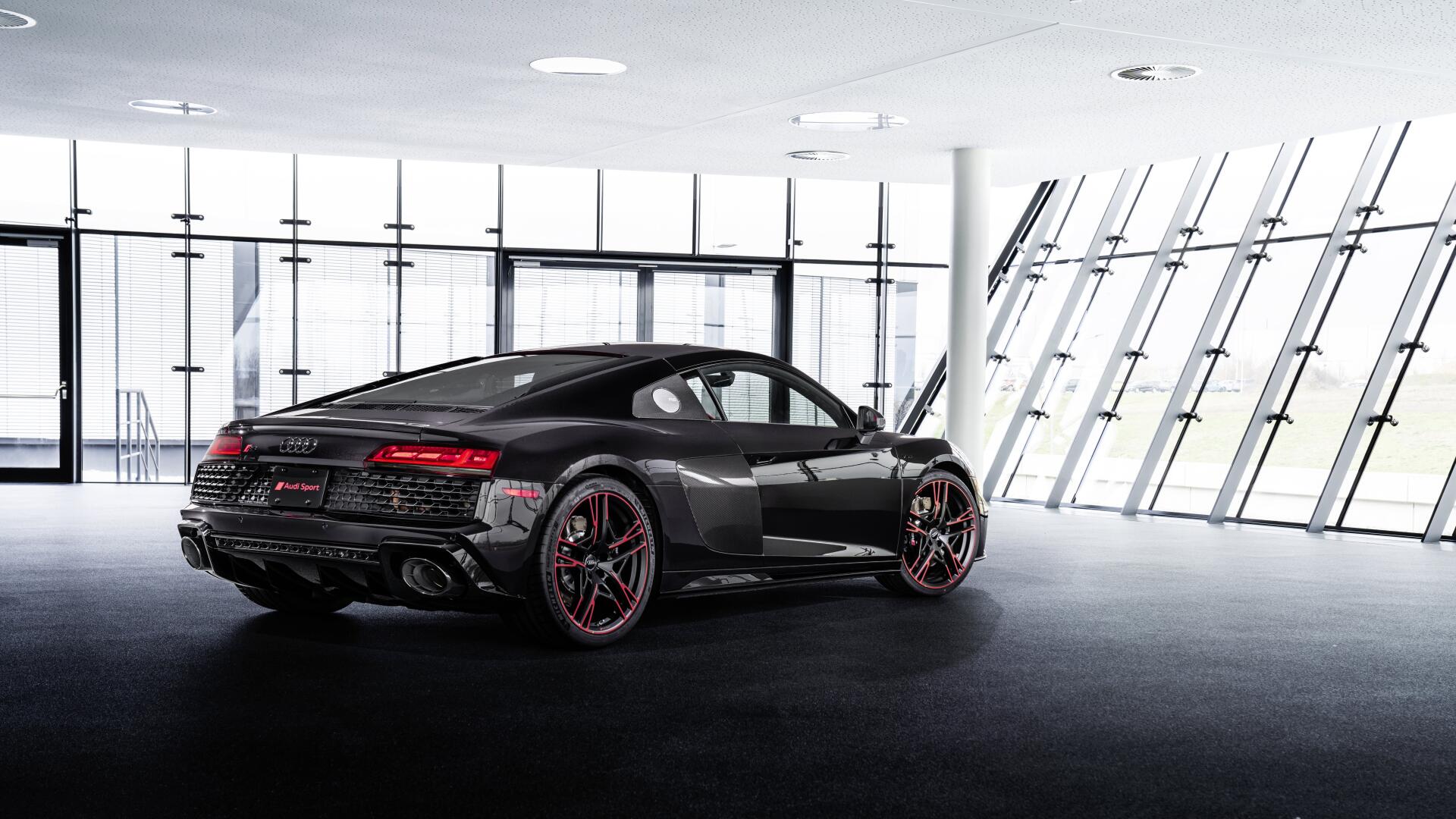 Black Audi R8 RWD luxury car in a bright glass showroom, rendered as an 8K Ultra HD PC desktop wallpaper and background.