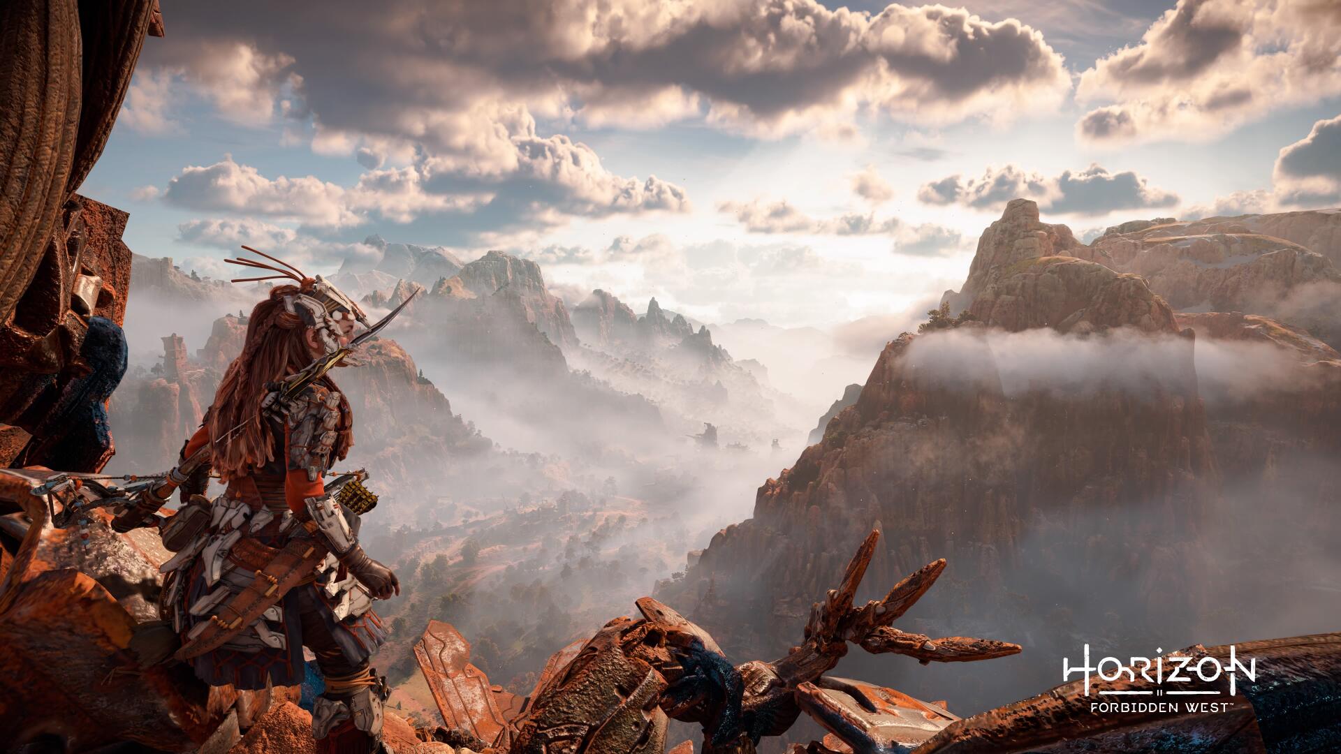 4K Ultra HD PC desktop wallpaper for the video game Horizon Zero Dawn: Aloy stands on a rocky ledge overlooking a misty canyon and a fallen robotic creature beneath a dramatic sky.