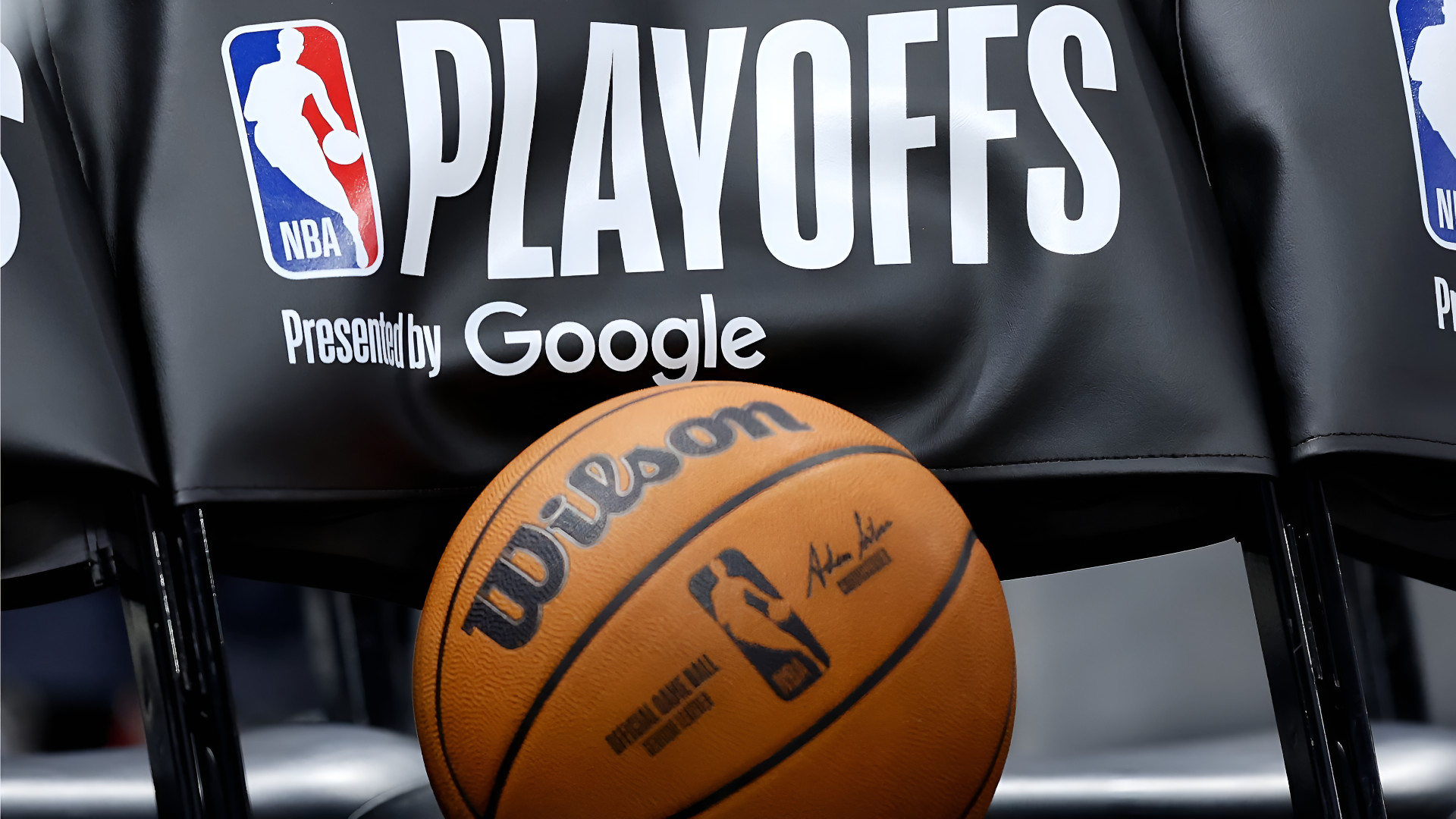 NBA playoffs scene: Wilson basketball on a chair with Playoffs and Google logos — 4K Ultra HD PC desktop wallpaper/background.