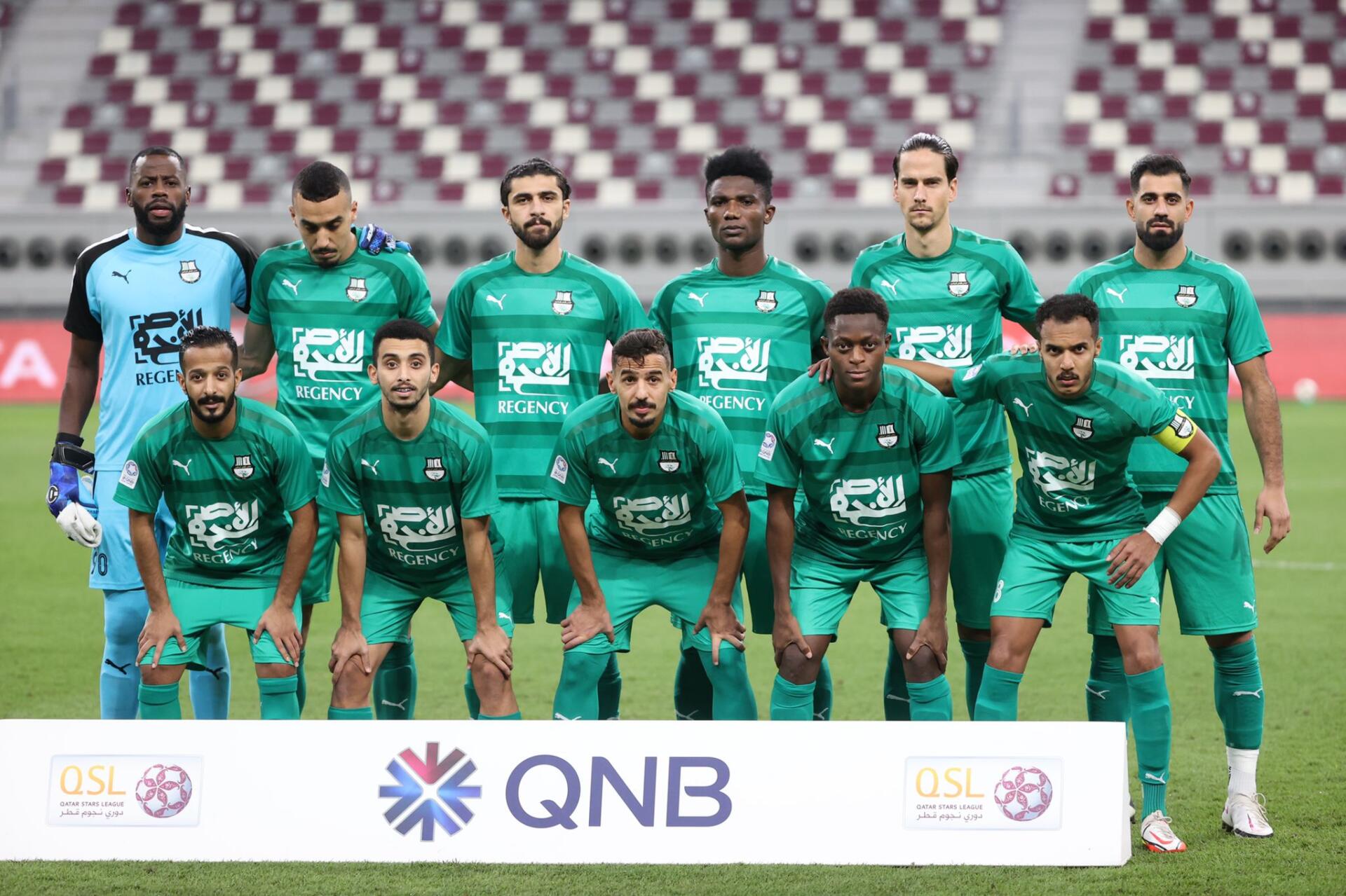HD desktop wallpaper: Al-Ahli Saudi FC squad lined up on the pitch before a Saudi Pro League soccer match.