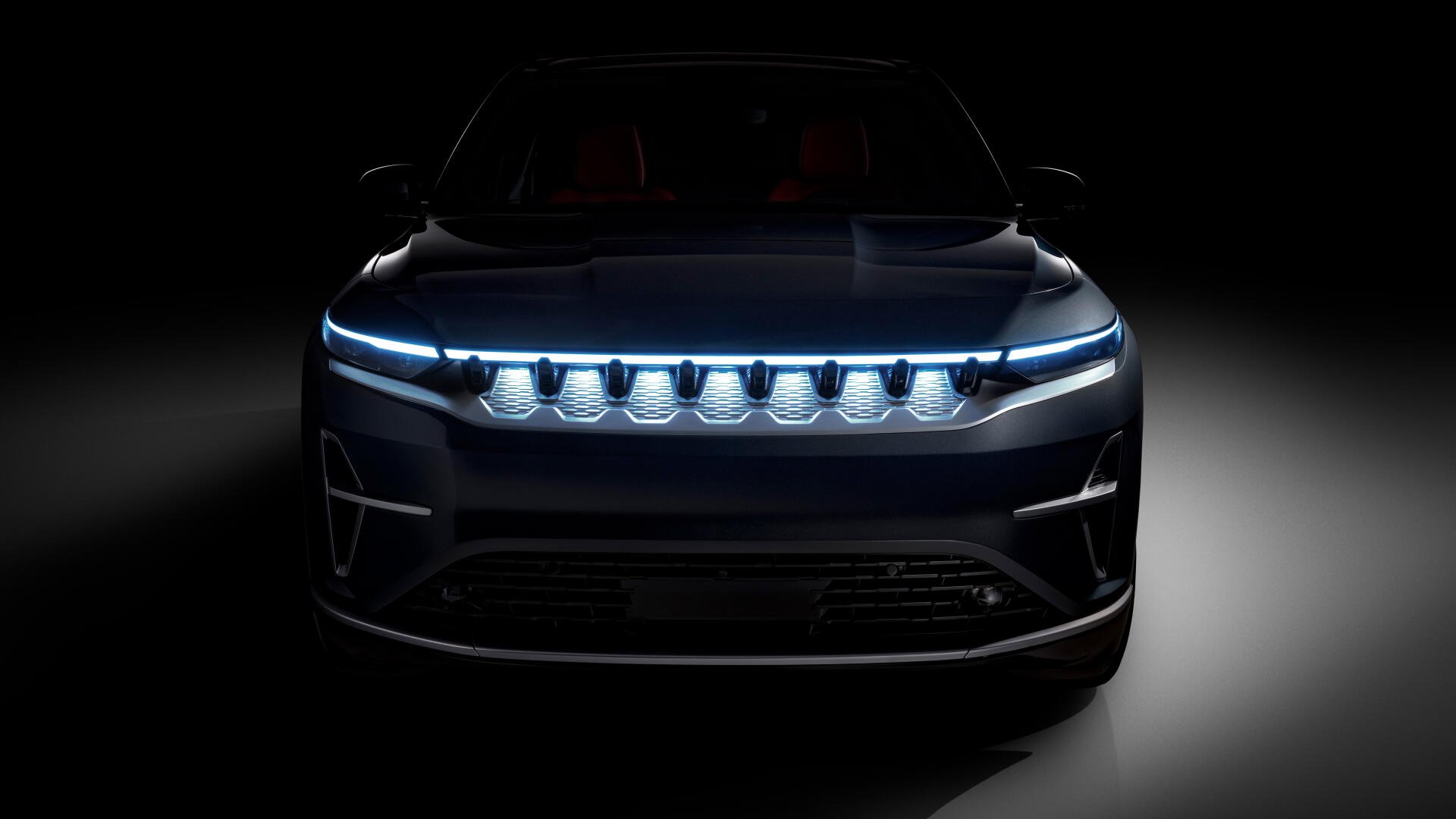 Front view of a Jeep Wagoneer S electric 4x4 with glowing LED grille and headlights, presented as an 8K Ultra HD PC desktop wallpaper/background.