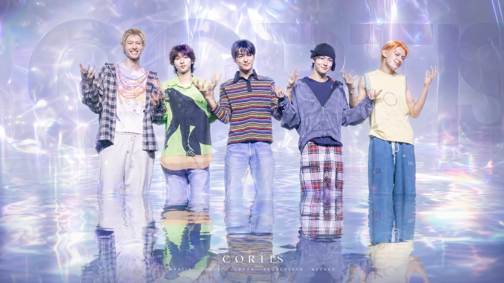 Image tagged Cortis: 4K Ultra HD PC desktop wallpaper of five smiling young men in colorful casual outfits posing amid iridescent, holographic light and reflective floor.