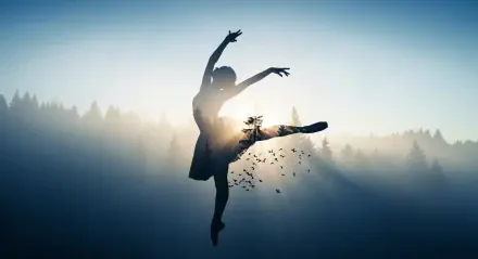 4K Ultra HD desktop wallpaper: silhouetted ballerina leaping, double-exposed with forest and birds against a misty sunrise.