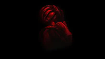 Red-lit Alien: Romulus creature emerging from darkness, cinematic close-up — 4K Ultra HD PC desktop wallpaper/background.