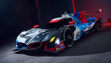 5K Ultra HD desktop wallpaper of a BMW M Hybrid V8 race car, showcasing bold livery, aerodynamic bodywork and dramatic studio track lighting.