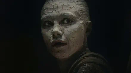 Close-up of a cracked, clay-like face in shadow from the movie Dune: Part Three, 2K Quad HD PC desktop wallpaper and background.