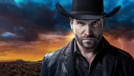 Brooding man in a black coat and cowboy hat against a stormy sunset desert horizon — El Señor de los Cielos HD PC desktop wallpaper and background.