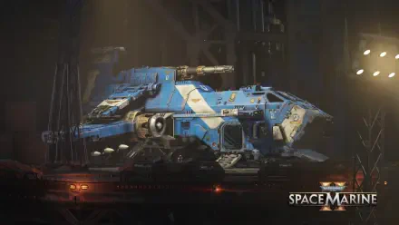 4K Ultra HD PC desktop wallpaper from the video game Warhammer Space Marine: a blue Space Marine armored transport in a dim industrial hangar, emblazoned with chapter insignia.