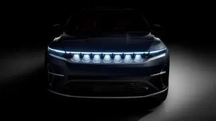 Front view of a Jeep Wagoneer S electric 4x4 with glowing LED grille and headlights, presented as an 8K Ultra HD PC desktop wallpaper/background.