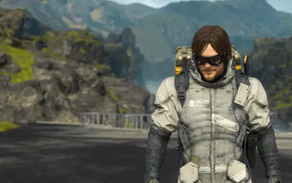 HD PC desktop wallpaper: Sam Porter Bridges from the video game Death Stranding 2: On The Beach, wearing an armored suit and sunglasses on a misty coastal road.