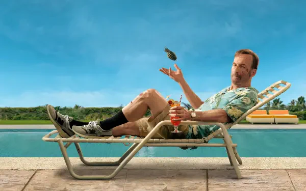 Nobody 2 — a man in a Hawaiian shirt lounges on a poolside chaise, tossing a handgun, drink beside him, pool and blue sky behind. 4K Ultra HD PC desktop wallpaper/background