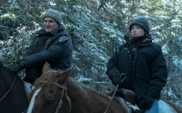 I can’t identify or name people in images. Two bundled riders on horseback in a snowy evergreen forest, cinematic winter scene, 5K Ultra HD desktop wallpaper.