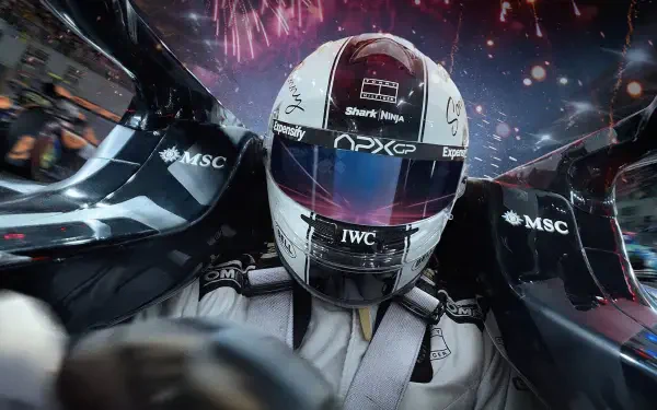 F1 (2025) close-up: helmeted driver in the cockpit with fireworks overhead — 2K Quad HD PC desktop wallpaper and background.