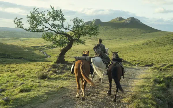 HD PC wallpaper of TV show A Knight of the Seven Kingdoms: three riders on horseback crossing a grassy field toward distant hills, evoking adventure.