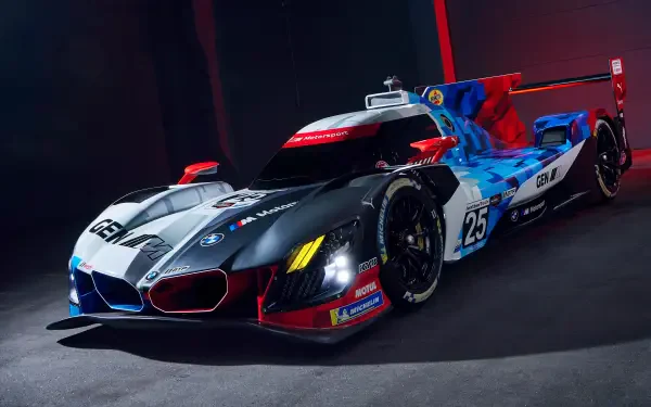 5K Ultra HD desktop wallpaper of a BMW M Hybrid V8 race car, showcasing bold livery, aerodynamic bodywork and dramatic studio track lighting.