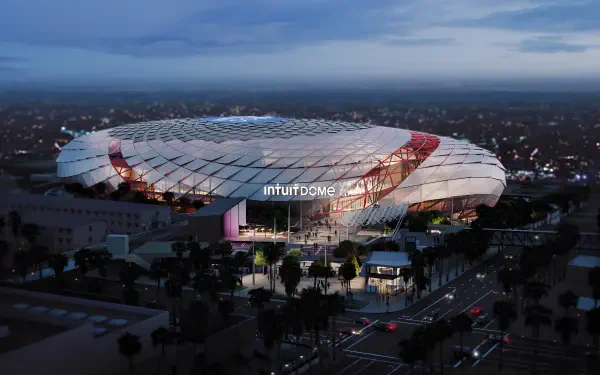4K Ultra HD PC desktop wallpaper: Intuit Dome in Inglewood, Los Angeles — modern stadium architecture glowing at dusk, aerial view of the arena and nearby streets.