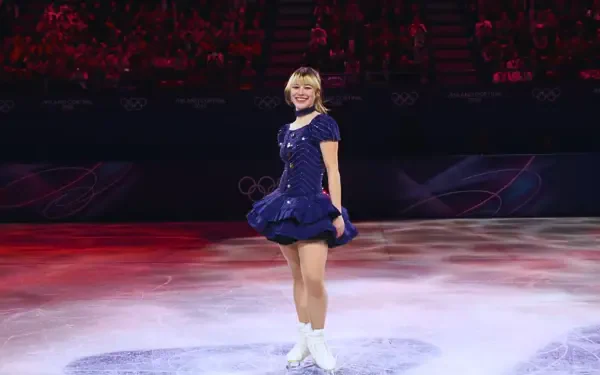 4K Ultra HD PC desktop wallpaper: figure skater in Team USA navy dress spins on Winter Olympics ice, bathed in lights amid a gold-medal celebration.