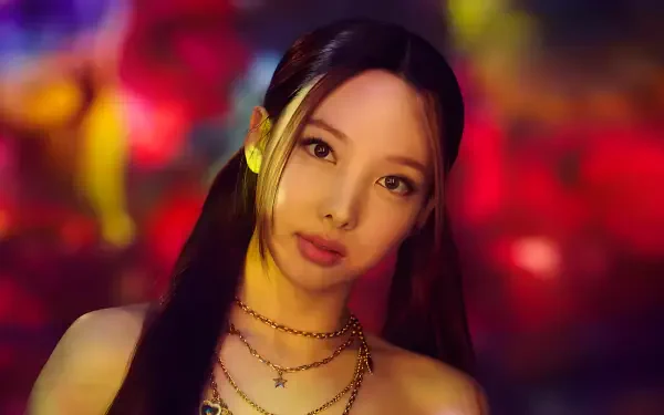Watercolor-style 4K Ultra HD desktop wallpaper of a long-haired female model styled like a K-pop singer, wearing layered necklaces and soft pigtails against a vivid, colorful bokeh background.